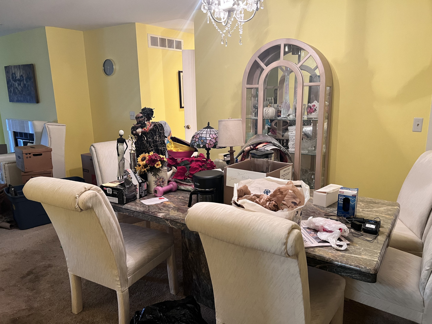 a table of personal items in a home in preparation for holding an estate sale