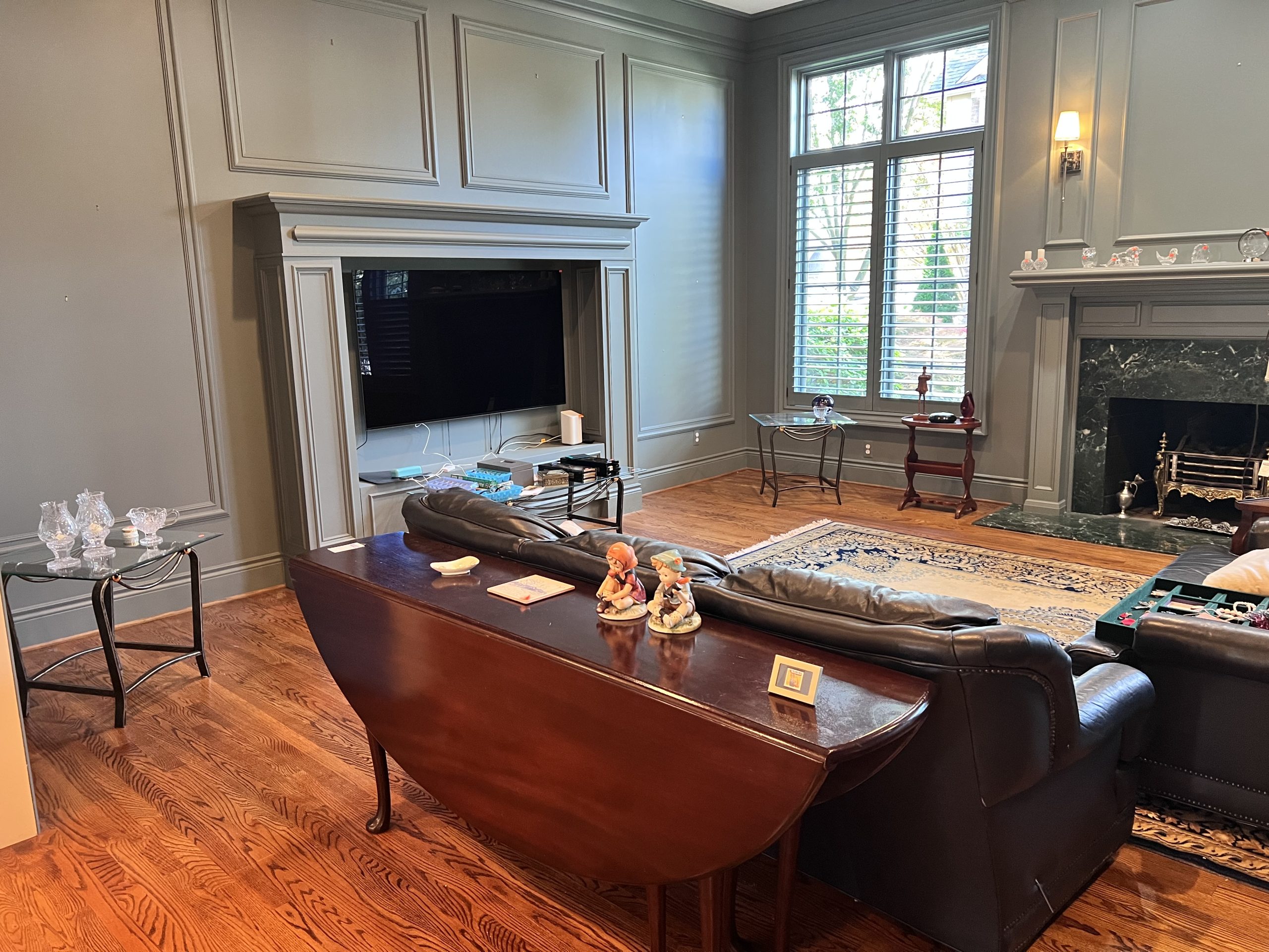 Estate liquidation living room with leather sofas and tv