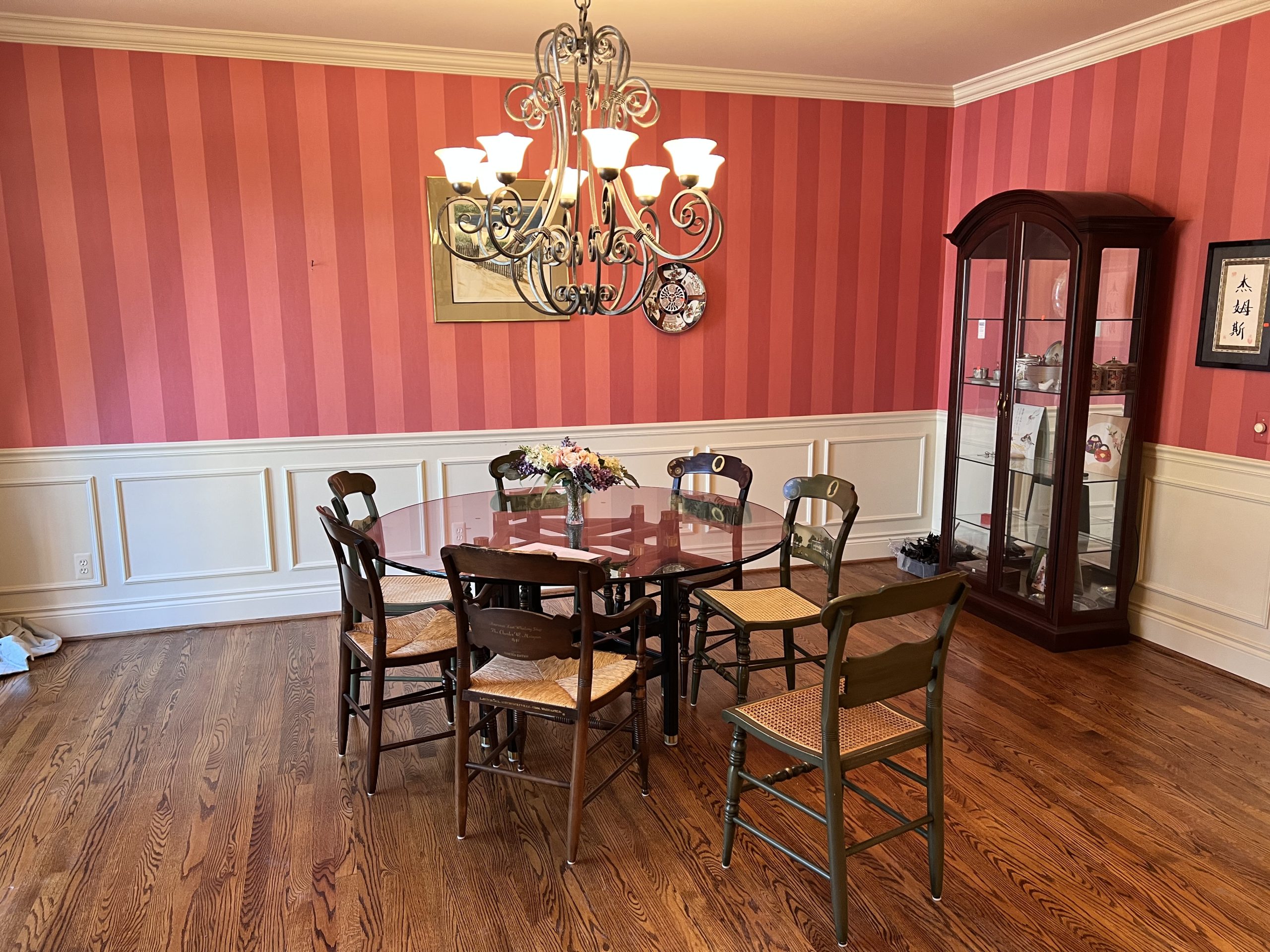 Dining room with Hancock presidential chairs, jasper curio cabinet and glass dining table