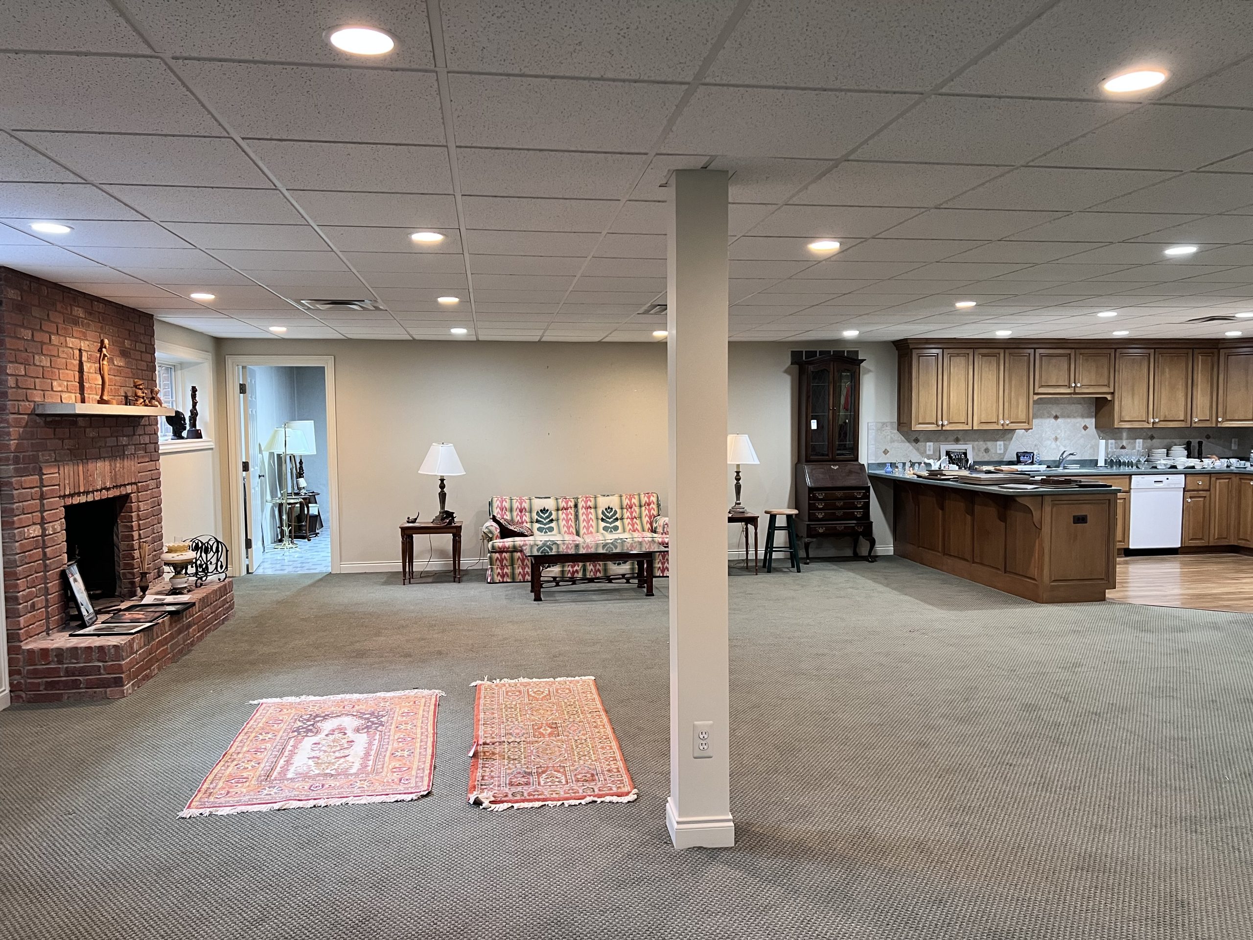 Estate sale basement with sofas, treadmill and more
