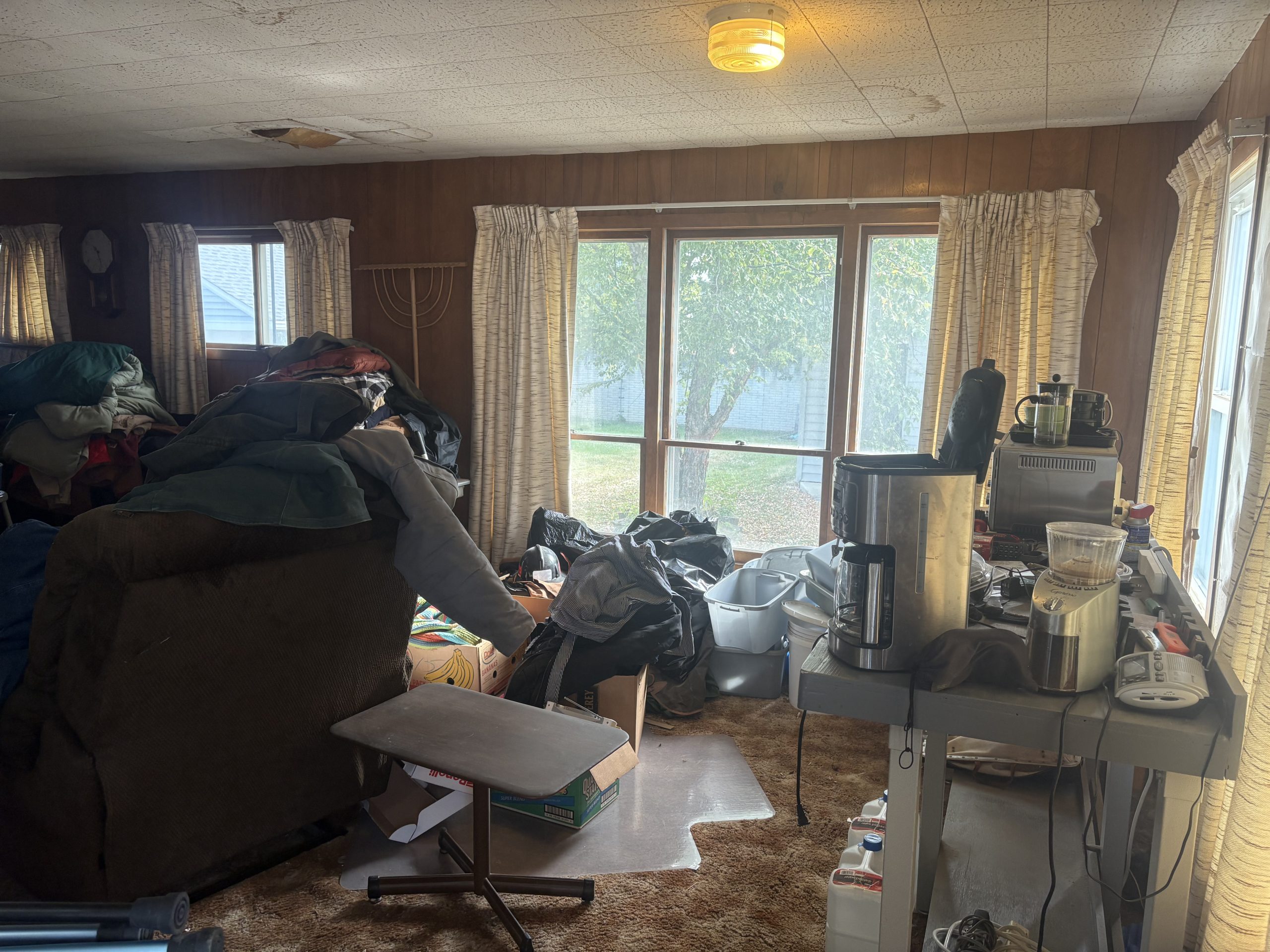 family room with clothes and junk
